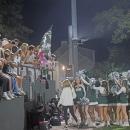 The cheerleaders and students celebrate together. 