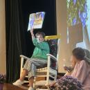 Tavares reads The Birthday Queen to the students. 