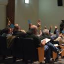 Town Meeting members vote to approve an article. 