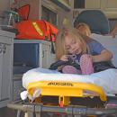 Hazely, age 4, buckles herself into the ambulance. 