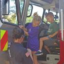 Declan and Claire learn more about the fire trucks. 