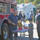 Abraham gets some free fire department merch. 