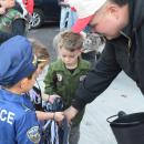 A firefighter hands out candy to some trick or treaters. 