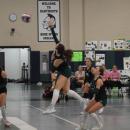 Madeline	Enos hits the ball over the net. 