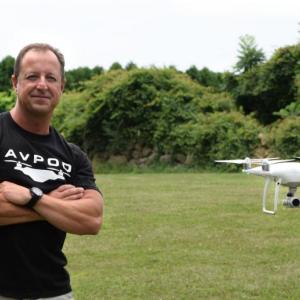 Anthony Franco poses for a photo next to his drone as it hovers nearby. BY DOUGLAS MCCULLOCH