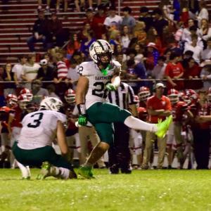 Michael Hauck kicks a field goal while Aidan Gendron holds. 