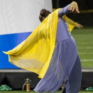 A member of the color guard dances. f
