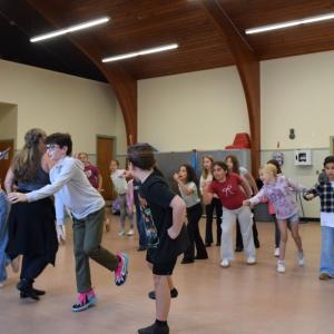 Kids practice the choreography. 