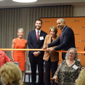 Governor Maura Healey and Manny Lopes cut the ribbon to open the PACE program in Dartmouth. 