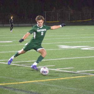 Carter Brennan kicks the ball back into play.