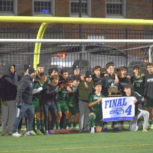 The Dartmouth High School boys soccer team poses with their Final 4 trophy and banner. Photos by Kat Sheridan