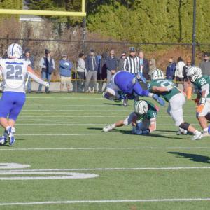 Brady Beauparland attempts to get the ball from a Fairhaven player, who jumps over him. 