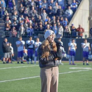 Emma Terach, a student at Dartmouth High School, sings the National Anthem. 
