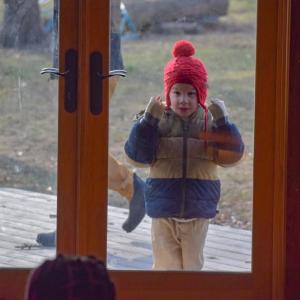 Miles McHenry, 6, looks into the building intrigued by the Kwanzaa celebration. 