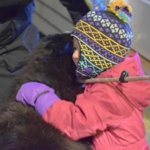 Aurora Cove, 2.5, gives a dog a hug.