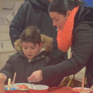 Alexander Couto, 6, decorates a cookie.