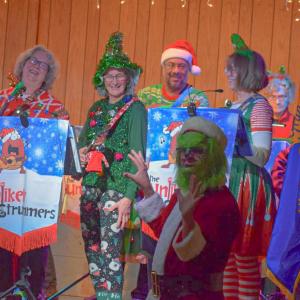 Deb Sorgman and Jen Wallance laugh as Jonathan Keller, dressed as the Grinch, entertains the crowd. Photos by Kat Sheridan