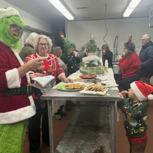 Lincoln Manely peeks at the Grinch from behind the cookie table. 