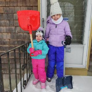 Adeline Santos and her cousin Sadie Thomas getting ready to shovel as the snow began to fall on Sunday. Source: Audra Thomas