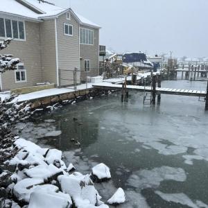 A snowy house on the water. Photo by Mari Huglin