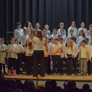 Students perform with boom whackers and hand drums. Photo by Kat Sheridan