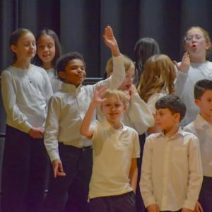 Students from the Potter School wave to family. Photo by Kat Sheridan
