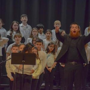 Music teacher Cameron Siegal prompts the crowd to participate. Photo by Kat Sheridan