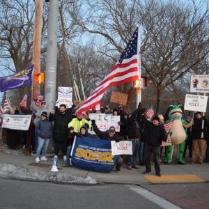 Protesters pose on the corner at the border of New Bedford and Dartmouth.