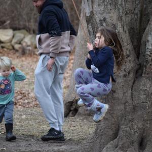 A four-year-old plays on the rope swing.