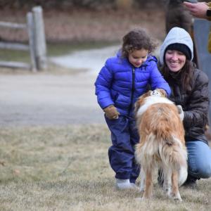 Bella, 4, and Marian Burgo pet the farm dog. 