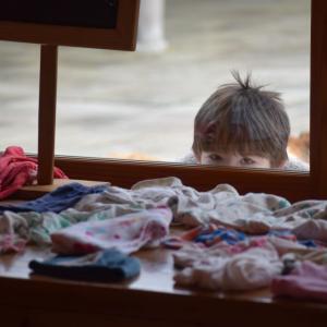 Will Bauer, 5, peeks in at the market.