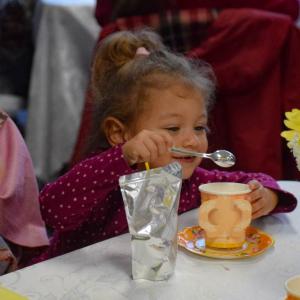 Lilian Grace Mather, age 2, perfects her tea.