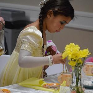 Kehlani Semedo, age 5, adds a bit more sugar to her tea.
