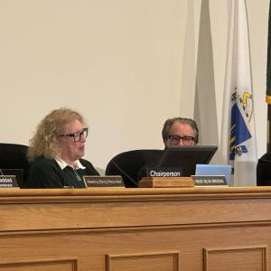 Heidi Silva-Brook gifts Stanley Mickelson his citation. 