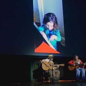 Leila Hijazi performs "Remember Me" from Encanto with photos of her as a child in the background.