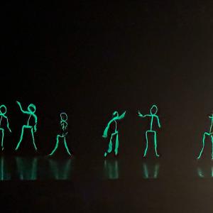 The first number featured glowing, dancing stick figures.