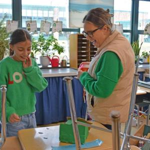 Christine Gideon and a student inspect evidence left on the desk.