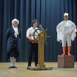 Grimsby (Hudson Igisomar), Prince Eric (Julian Lazaro) and Scuttle (Nyah Suarez) pose onstage.