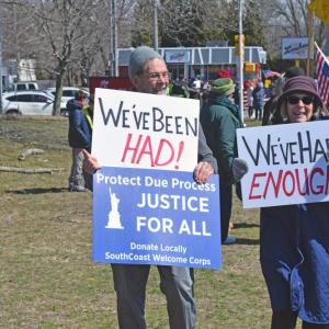 A couple shows off their signs. 