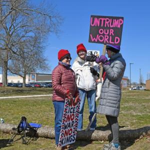 A group has a conversation while protesting.