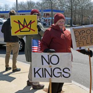 A woman demands no kings as a part of her protest.