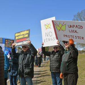 Many of the signs called for no kings.