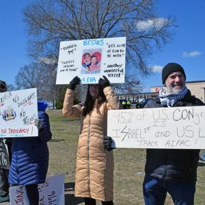 Some of the protesters standing and protesting together.