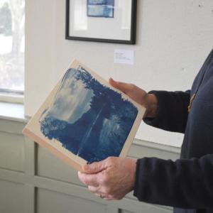 Jill Law holds one of her works. 