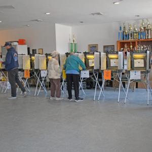 Voters at the Dartmouth Youth Athletic Association fill in their ballots. 
