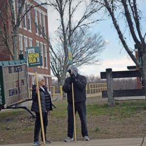 Two people campaign for Nathan Silva outside Town Hall. 