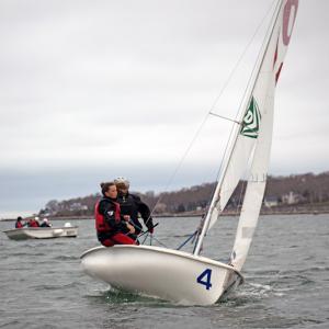 Maisy Sperry, an alumnus, returned to help with practice, sails with Phoebe Murray. 