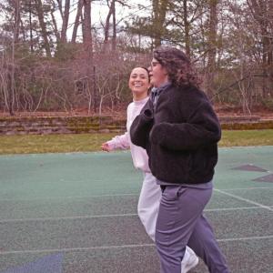 Emma Garcia and Alexis Benjamin run together. 