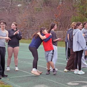 Teammates cheer each other on during 100m trials. 