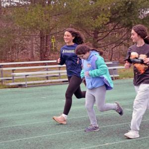 Delilah Dellecese runs alongside Hayden Barriteau and Etta Hall.